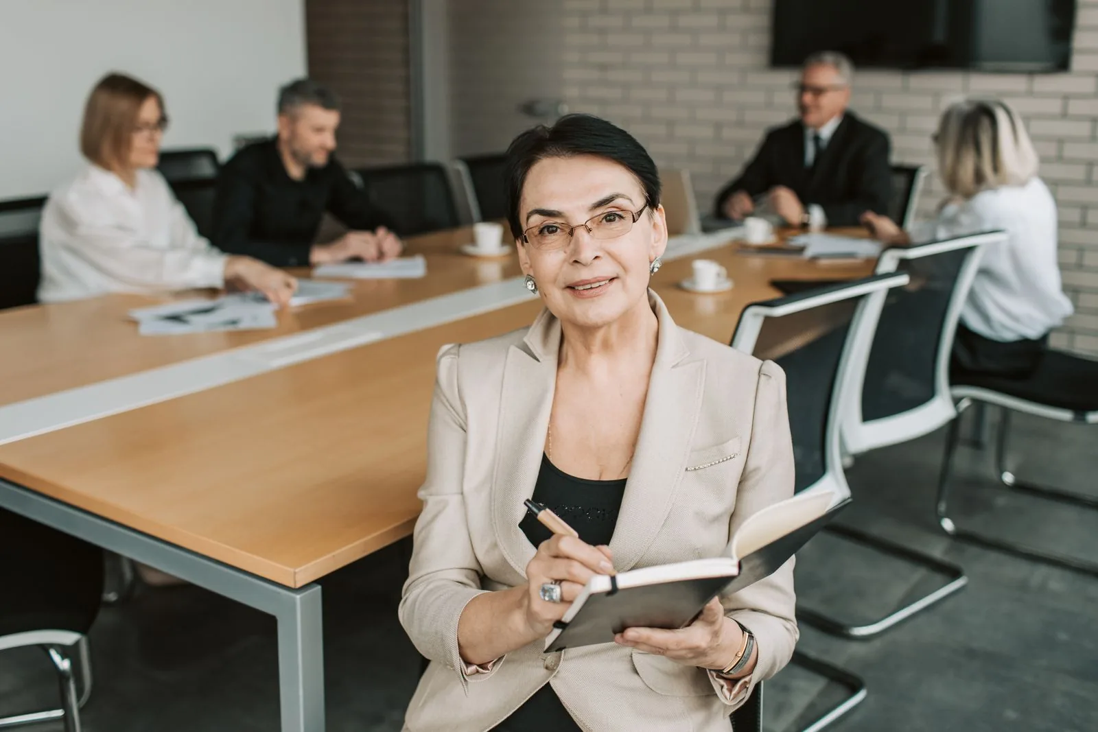 Senior finance executive leading a discussion at the head of a boardroom table
