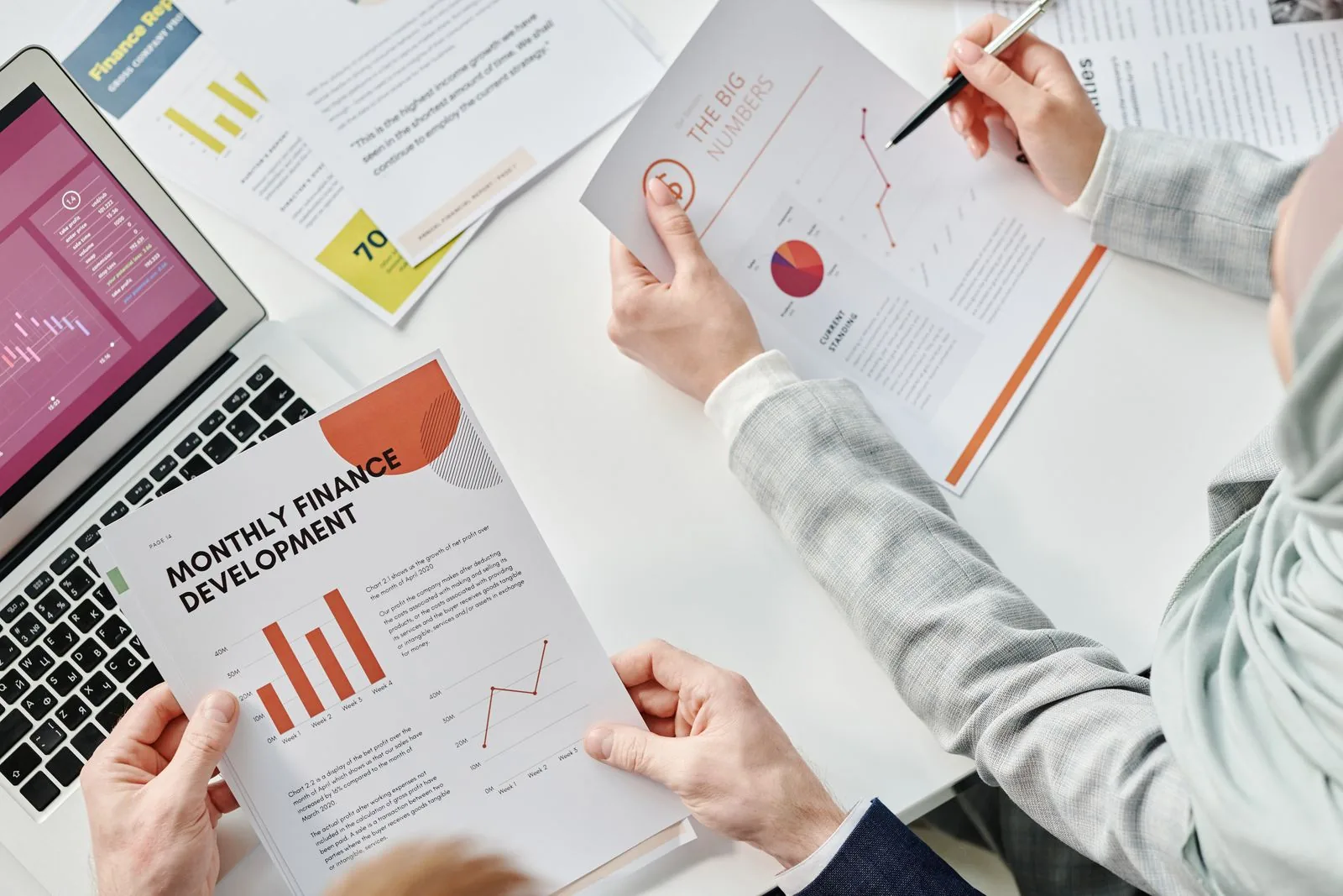 Specialists reviewing Oracle Fusion close documents and reports